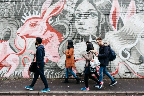 Students walking past some street art in Birmingham