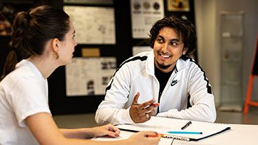 Male and female students working together