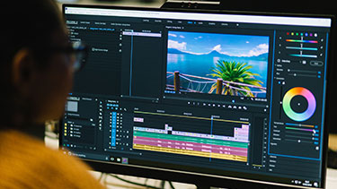 Student editing a video with computer software