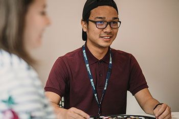 Male student studying with other people