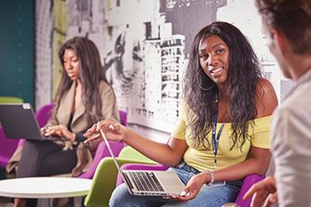 Students with laptops in a group study