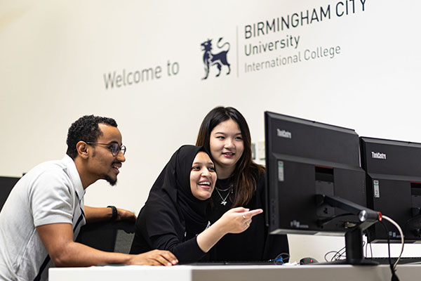 Students working together on a computer at BCUIC college
