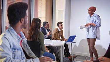 Student studying and presenting in classroom