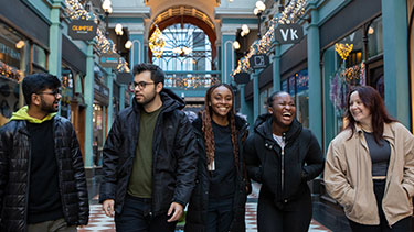 Group of students walking though a Birmingham shopping arcade