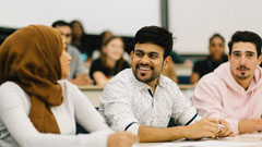 Students smiling and talking during lecture