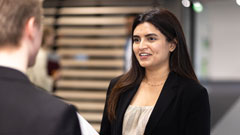 Girl in corporate outfit in discussion with someone