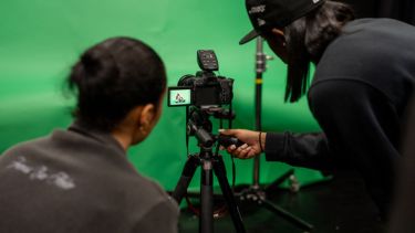 Students in the green screen