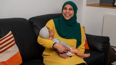 Woman smiling while holding baby