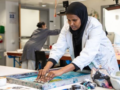 Student doing fabric printing in a workshop