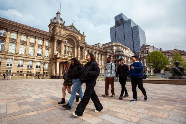 Group of students walking through the city centre