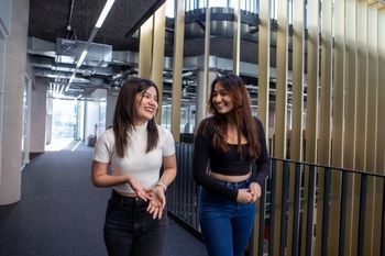 Two students walking together and chatting