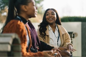 Students sitting outside and chatting